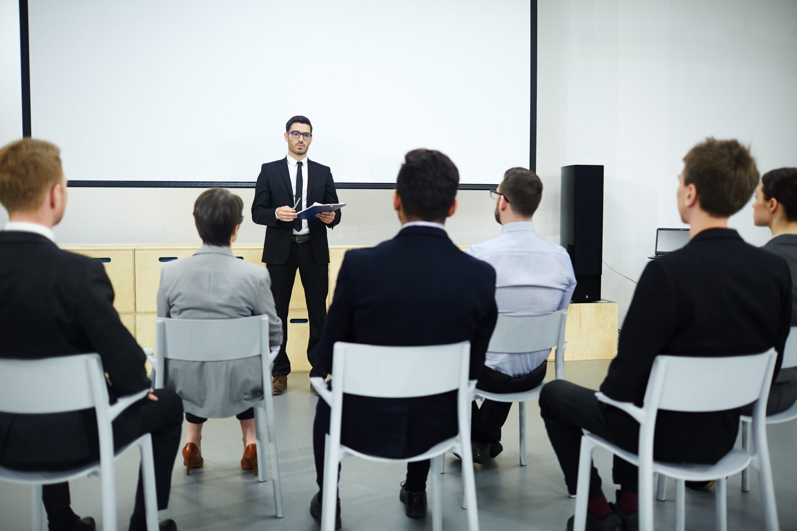 Qualification training Rear view of audience listening to speech of successful business professional